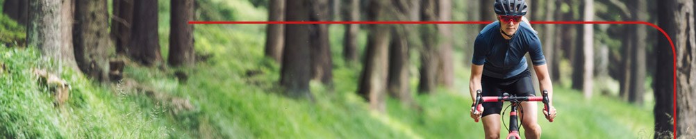 Female cyclist in forest setting