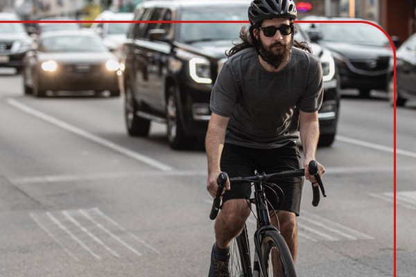 A commuter riding amongst city traffic