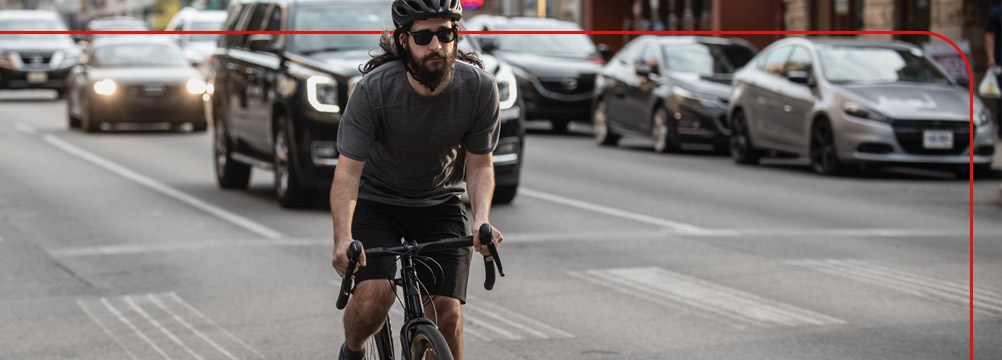 A commuter riding amongst city traffic