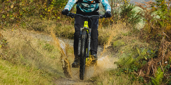 A cycling uses a rear mudguard to stop road spray flinging upwards and over his back