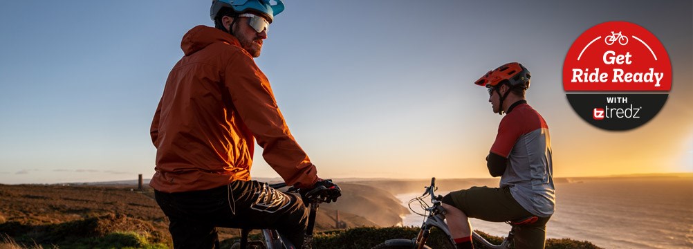 Two mountain bikers near the sea on a spring day