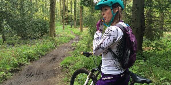 A mountain biker uses a hydration pack