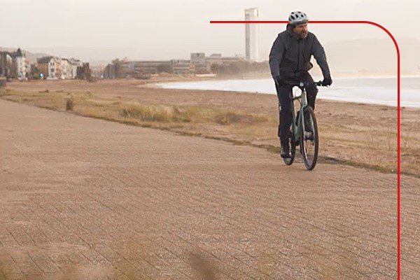 Cycle commuter riding along the seafront