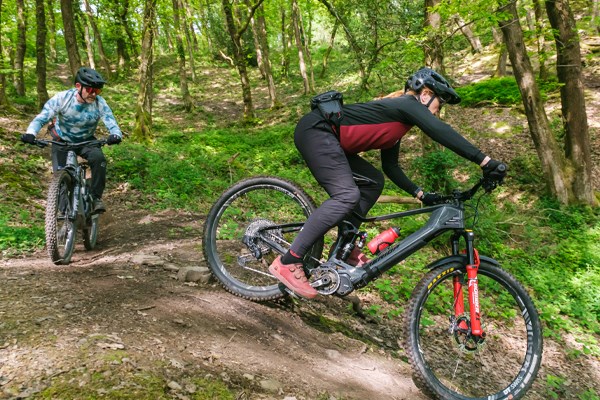 Woman riding a Merida e-bike in the woods