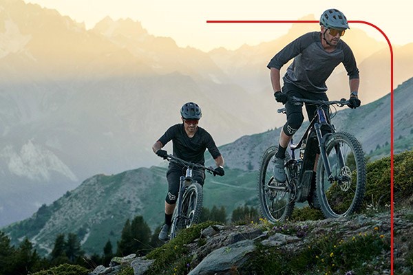 Two mountain bikers on a climb using Giant Trance X E+ E-Bikes