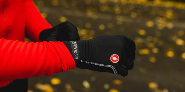 A road cylist wearing winter clothing.