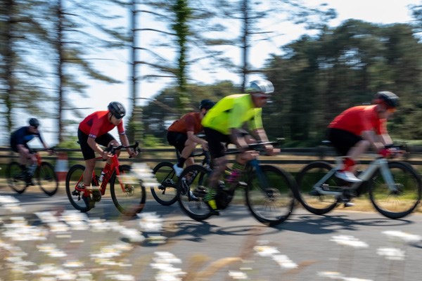 Two road cyclists riding along a rural road