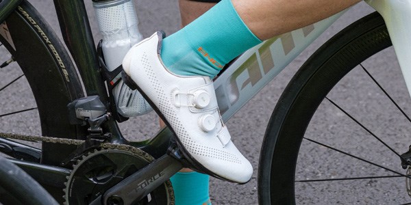 A female road cyclist wearing summer cycle clothing.