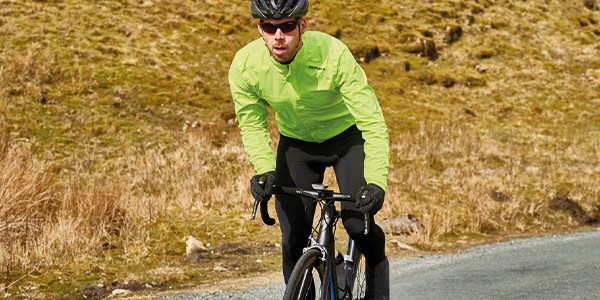 A road cylist wearing winter clothing.