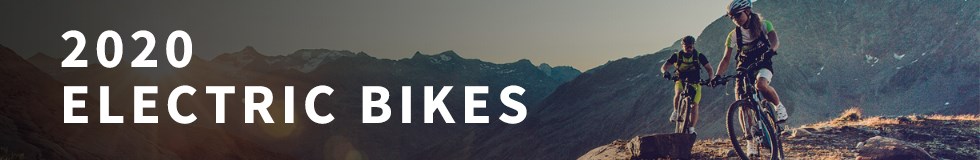 Two mountain bikers riding up a climb on Haibike Electric MTBs