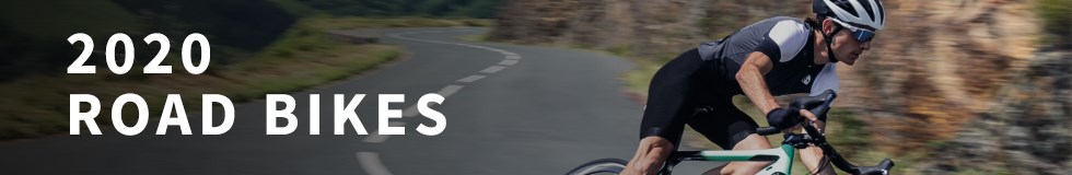 A road cycling riding along a winding road on a 2020 Cannondale road bike