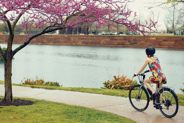 female biker cycling by the river